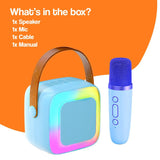 Family Fun Karaoke Machine portable speaker and wireless microphone set with colorful LED lights and brown handle against orange background