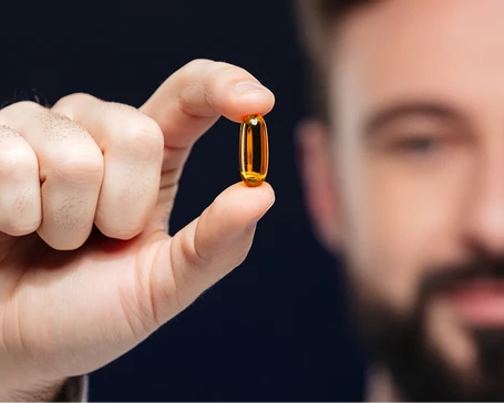 Close-up of an amber softgel